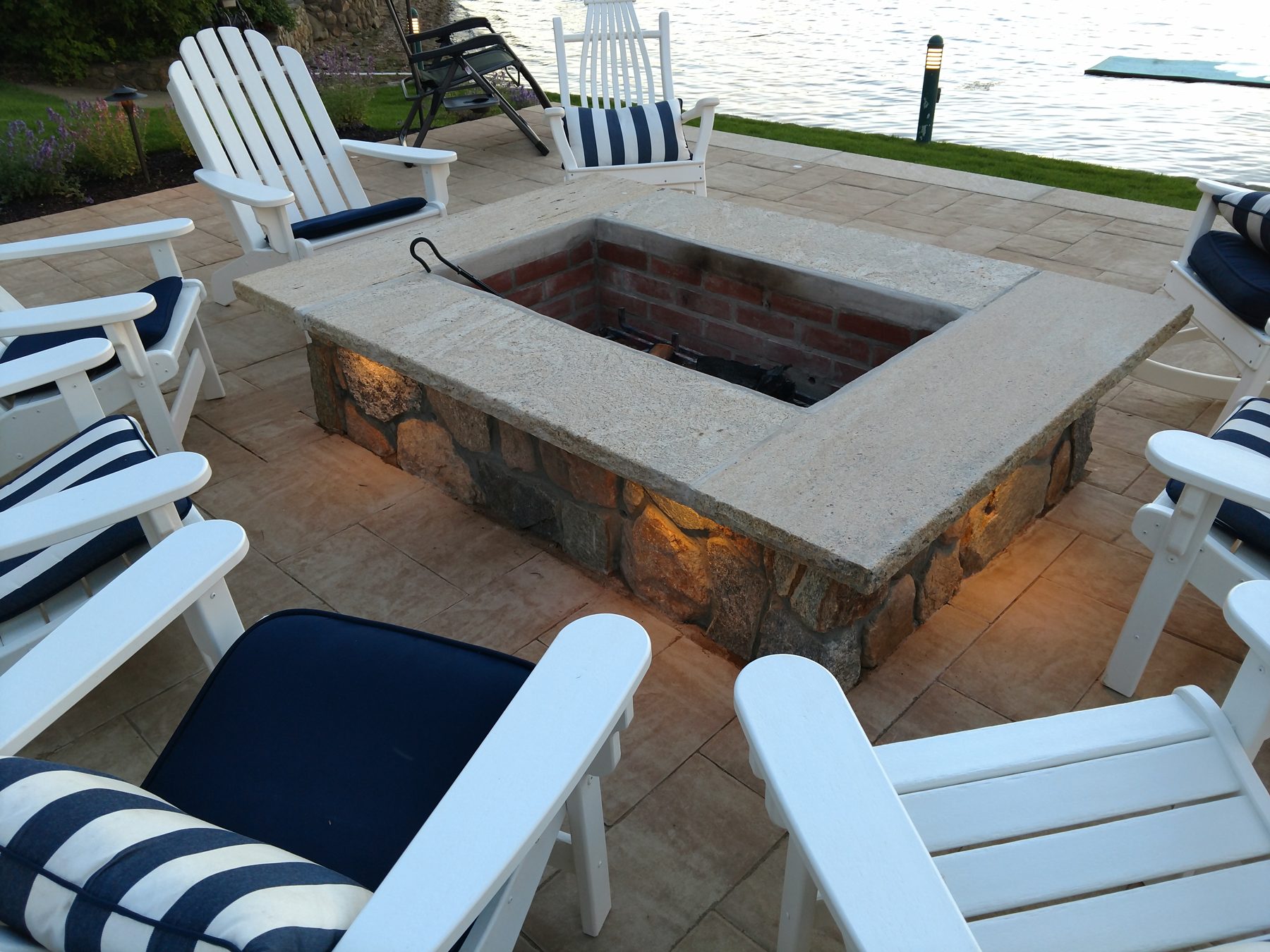 Backyard fire pit with landscape lighting
