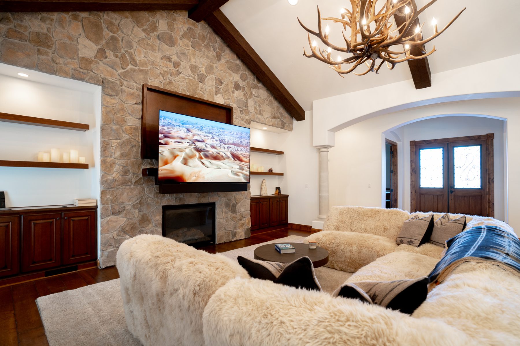 Family room TV over a stone fireplace