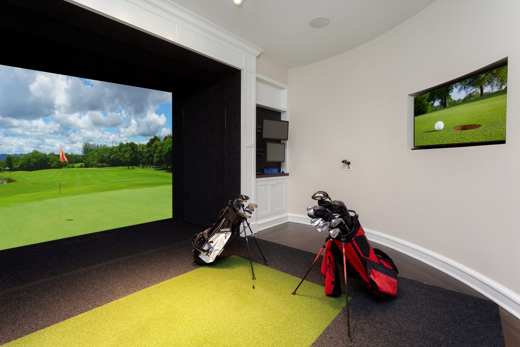 Golf simulator room with a wall-mounted TV