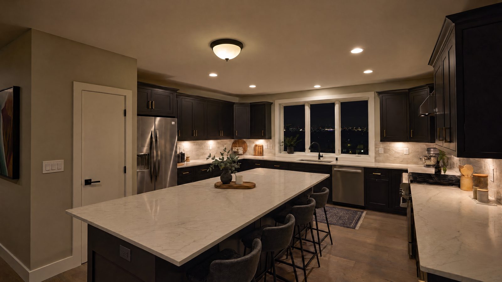 Kitchen at night before: one dome ceiling light, a few recessed lights and standard switches