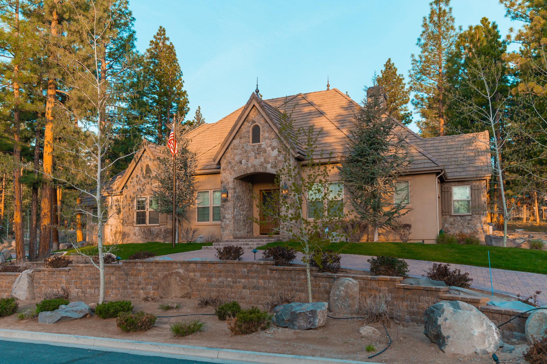 Home exterior with landscape lighting and pool